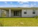 A view of the home's backyard and covered patio space at 2518 Chapel Oak Bnd, Wesley Chapel, FL 33543