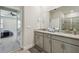 Bathroom featuring a granite countertop, double sinks, and access to the bedroom at 2518 Chapel Oak Bnd, Wesley Chapel, FL 33543