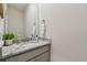 Stylish half bathroom featuring granite counters, a decorative mirror, and ample counter space at 2518 Chapel Oak Bnd, Wesley Chapel, FL 33543