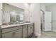 Bathroom featuring a granite countertop, double sinks, and access to the shower at 2518 Chapel Oak Bnd, Wesley Chapel, FL 33543