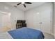 Bedroom with a desk area for work or study, complemented by a blue patterned bed at 2518 Chapel Oak Bnd, Wesley Chapel, FL 33543