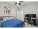 Comfortable bedroom featuring a desk area for work, plus a bed dressed with a patterned blue coverlet at 2518 Chapel Oak Bnd, Wesley Chapel, FL 33543