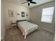 Inviting bedroom with neutral gray walls, a patterned bedspread, and whimsical animal artwork on the wall at 2518 Chapel Oak Bnd, Wesley Chapel, FL 33543