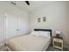 Cozy bedroom featuring a full-sized bed with neutral linens and a nightstand beneath framed wall art at 2518 Chapel Oak Bnd, Wesley Chapel, FL 33543