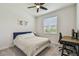 Serene bedroom with a queen-size bed, desk, and natural light at 2518 Chapel Oak Bnd, Wesley Chapel, FL 33543