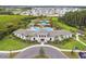 A beautiful clubhouse featuring lush landscaping, a circular driveway, and ample parking spaces at 2518 Chapel Oak Bnd, Wesley Chapel, FL 33543