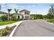 Community center featuring well-maintained landscaping, light-colored stucco and siding, and an entrance walkway at 2518 Chapel Oak Bnd, Wesley Chapel, FL 33543