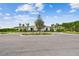 Community center with well-maintained landscaping, light-colored stucco and siding, and circular drive at 2518 Chapel Oak Bnd, Wesley Chapel, FL 33543