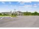 Community center featuring well-maintained landscaping, light-colored stucco and siding, and ample parking at 2518 Chapel Oak Bnd, Wesley Chapel, FL 33543