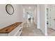 Bright foyer featuring tile flooring, accent table, and views into the living spaces at 2518 Chapel Oak Bnd, Wesley Chapel, FL 33543