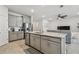 Bright kitchen with large island, stainless steel appliances, and gray cabinetry at 2518 Chapel Oak Bnd, Wesley Chapel, FL 33543