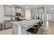 Kitchen island with granite countertops, stainless steel appliances, and seating at 2518 Chapel Oak Bnd, Wesley Chapel, FL 33543