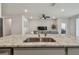 Kitchen island with a view of the open floorplan featuring the living room at 2518 Chapel Oak Bnd, Wesley Chapel, FL 33543