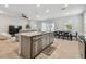 Open kitchen features a kitchen island with stainless steel appliances and breakfast bar at 2518 Chapel Oak Bnd, Wesley Chapel, FL 33543