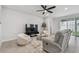 Cozy living room with comfortable seating, a large TV, and neutral decor at 2518 Chapel Oak Bnd, Wesley Chapel, FL 33543