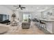 Open-concept living room with tile flooring, modern furnishings, and abundant natural light at 2518 Chapel Oak Bnd, Wesley Chapel, FL 33543