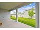 View of the backyard from a covered patio with support columns at 2518 Chapel Oak Bnd, Wesley Chapel, FL 33543