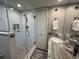 Bright bathroom featuring a glass enclosed shower, stone vanity, and natural light at 2716 11Th Ct, Palm Harbor, FL 34684