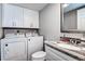 Updated bathroom with laundry appliances and a granite vanity at 2716 11Th Ct, Palm Harbor, FL 34684