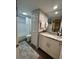 Bright bathroom features a spacious vanity with granite countertop and tiled shower/tub at 2716 11Th Ct, Palm Harbor, FL 34684