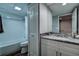 Bathroom features granite countertop, white cabinetry, and tiled shower/tub combo at 2716 11Th Ct, Palm Harbor, FL 34684