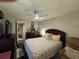 Comfortable bedroom with neutral-toned decor, ceiling fan, and a cozy seating area at 2716 11Th Ct, Palm Harbor, FL 34684