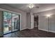 The bedroom has a fan, hardwood flooring and a sliding glass door leading to a balcony at 2716 11Th Ct, Palm Harbor, FL 34684
