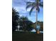 Scenic community lake view with palm trees and fountain feature, perfect for residents to relax and enjoy the outdoors at 2716 11Th Ct, Palm Harbor, FL 34684
