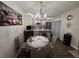 Cozy dining area with decorative artwork, chandelier and breakfast bar overlooking the kitchen at 2716 11Th Ct, Palm Harbor, FL 34684
