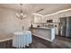 Bright kitchen area features stainless steel appliances, white cabinetry, and an adjacent dining space at 2716 11Th Ct, Palm Harbor, FL 34684