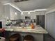 Modern kitchen with stainless steel appliances, granite countertops, and a breakfast bar at 2716 11Th Ct, Palm Harbor, FL 34684