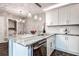 Bright kitchen featuring white cabinets, granite countertops, and stainless steel appliances at 2716 11Th Ct, Palm Harbor, FL 34684