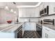 Bright kitchen featuring white cabinets, granite countertops, and stainless steel appliances at 2716 11Th Ct, Palm Harbor, FL 34684