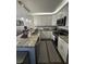Modern kitchen with white cabinets, stainless steel appliances, and granite countertops at 2716 11Th Ct, Palm Harbor, FL 34684