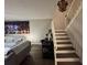 Comfortable living room with seating, stair access and art at 2716 11Th Ct, Palm Harbor, FL 34684