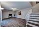 Open-concept living area with wood floors, ceiling fan and stairs to the second level at 2716 11Th Ct, Palm Harbor, FL 34684