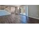 Open living area with wood floors, staircase, and sliding glass doors to the backyard at 2716 11Th Ct, Palm Harbor, FL 34684