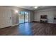 This living room features new wood floors and sliding doors, providing a modern look and connection to the outdoors at 2716 11Th Ct, Palm Harbor, FL 34684