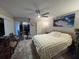 Spacious main bedroom with a plush rug, sliding closet doors and a calming waterfall art piece at 2716 11Th Ct, Palm Harbor, FL 34684