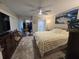 Bright main bedroom boasts ceiling fan, a calming waterfall art piece and comfortable furniture at 2716 11Th Ct, Palm Harbor, FL 34684