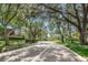 Shaded street leading to property with mature trees at 2716 11Th Ct, Palm Harbor, FL 34684