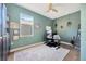 Versatile room with hardwood floors, colorful walls, with a ceiling fan, and window view at 31241 Kirkshire Ct, Wesley Chapel, FL 33543
