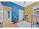 Colorful bedroom with blue, yellow, and white tones featuring hardwood floors at 31241 Kirkshire Ct, Wesley Chapel, FL 33543
