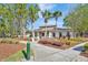 Inviting community clubhouse with a covered porch, mature landscaping, and sidewalk access at 31241 Kirkshire Ct, Wesley Chapel, FL 33543