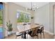 Dining area featuring a modern light fixture and a view of the backyard pool at 31241 Kirkshire Ct, Wesley Chapel, FL 33543