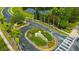 Community entrance with manicured landscaping and a prominent Heatherstone sign near a scenic pond at 31241 Kirkshire Ct, Wesley Chapel, FL 33543