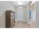 Inviting foyer features neutral paint, tiled flooring, and decorative light fixture at 31241 Kirkshire Ct, Wesley Chapel, FL 33543
