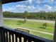 Relaxing balcony view overlooking green space and a road with lush trees beyond at 320 N Bayshore Blvd # 203, Clearwater, FL 33759
