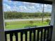 Balcony view with lush greenery, street, and beautiful sky in the background at 320 N Bayshore Blvd # 203, Clearwater, FL 33759