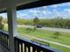 Comfortable balcony overlooking landscaped green space, a road, and lots of shady trees at 320 N Bayshore Blvd # 203, Clearwater, FL 33759